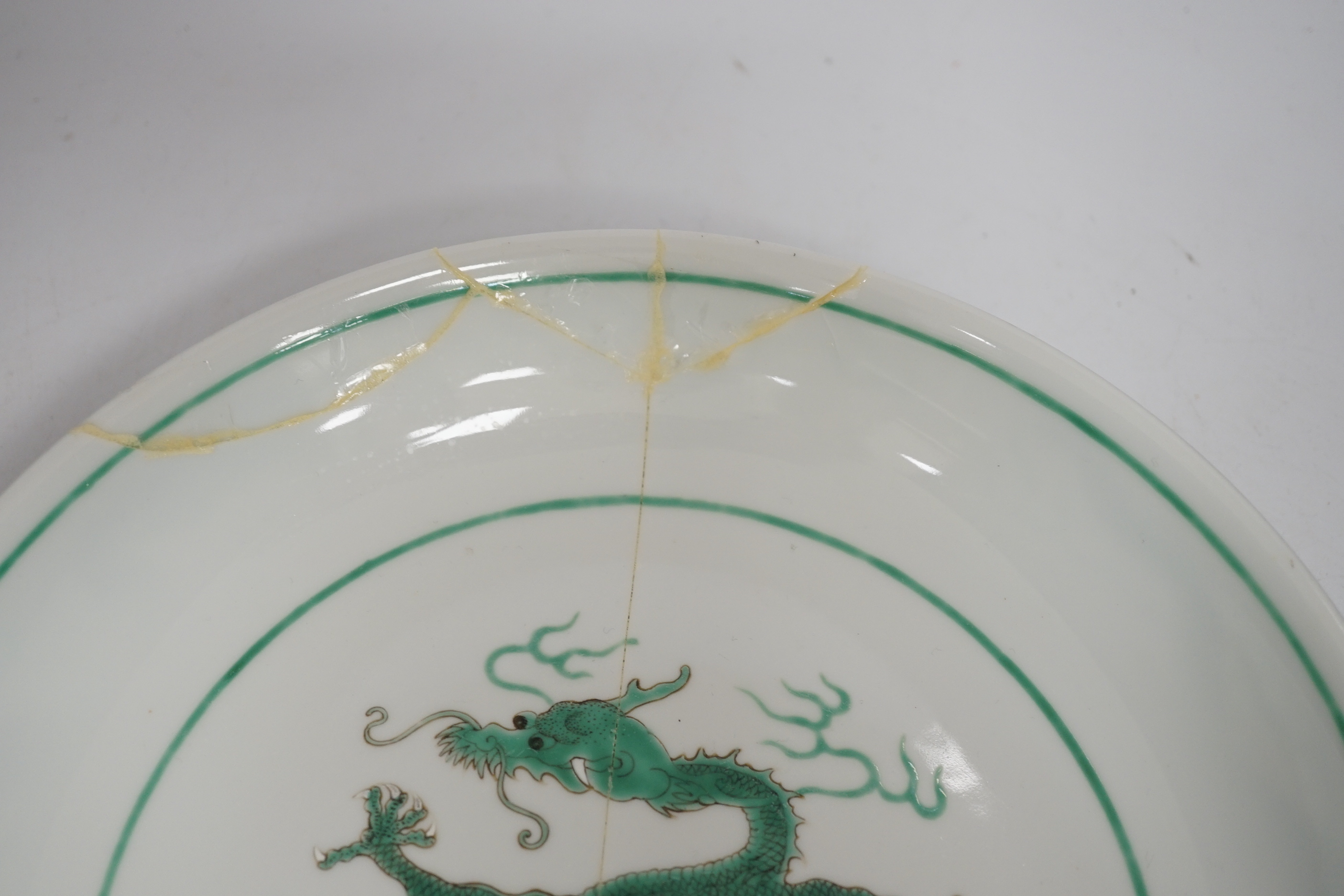 A Chinese green enamelled porcelain ‘dragon’ dish, 24cm in diameter (a.f.)